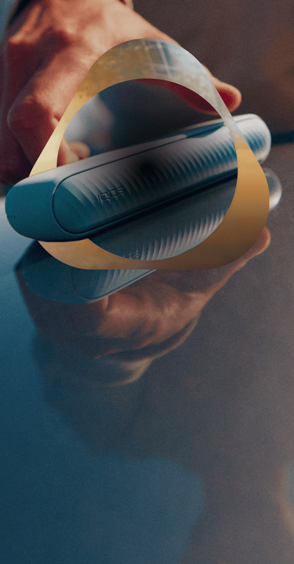 Hand reaching for an IQOS ILUMA i device