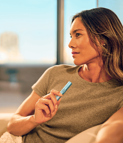 A woman enjoying her iqos
