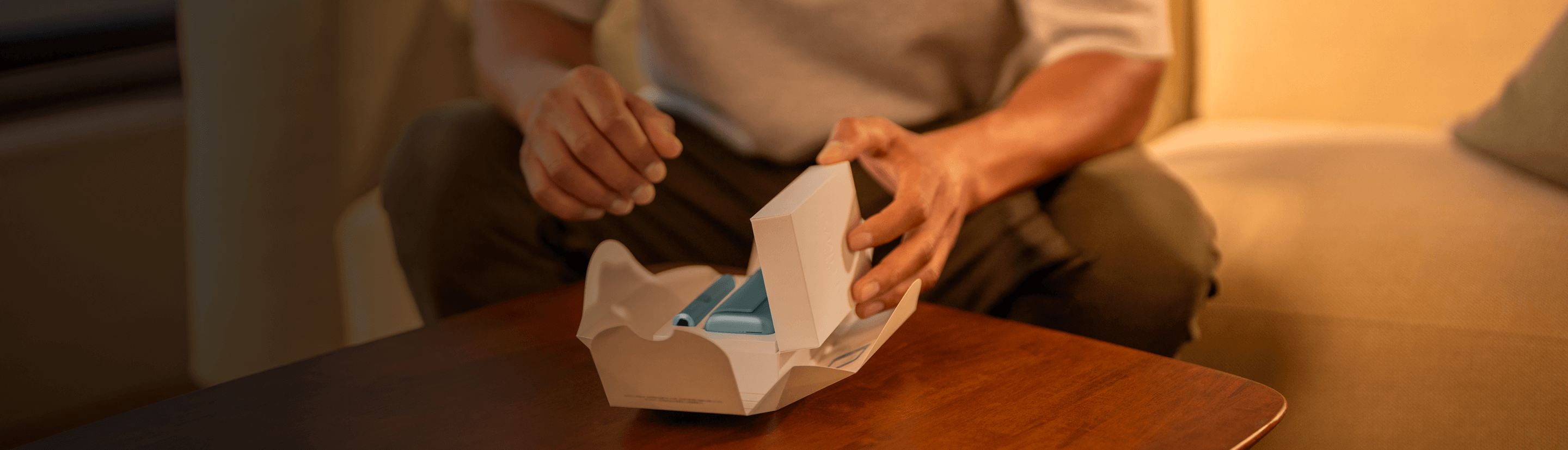 Young man opens his IQOS gift box