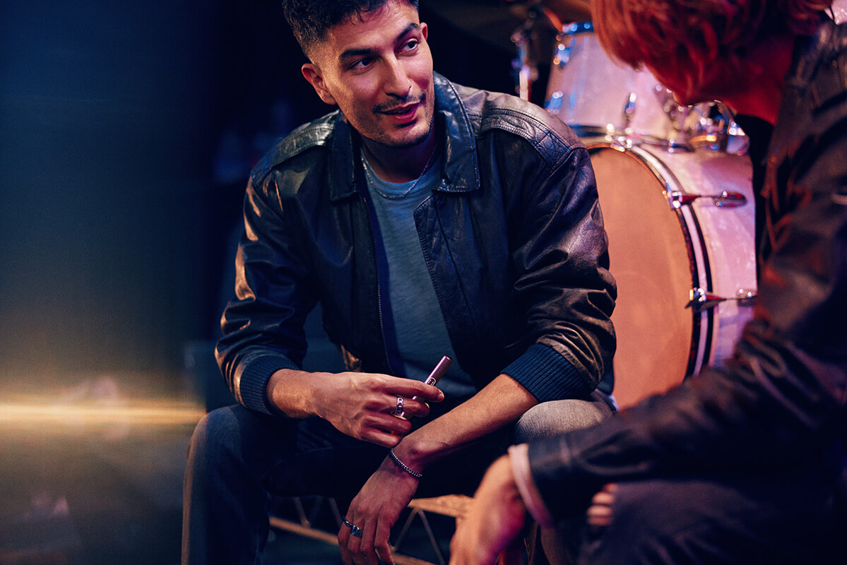A woman opening a package from IQOS.