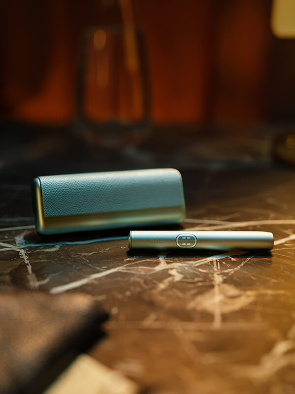 An IQOS ILUMA Holder and Pocket Charger.