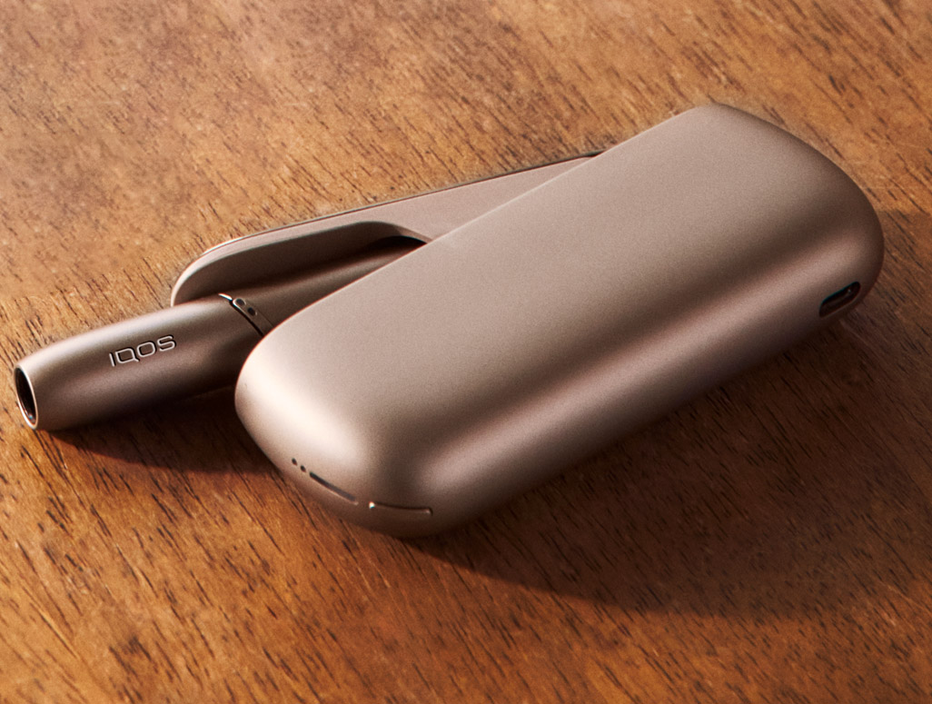 Man showing a gold IQOS holder