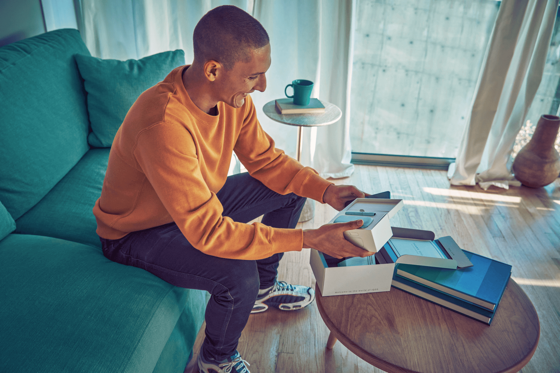 Young man opens his IQOS gift box