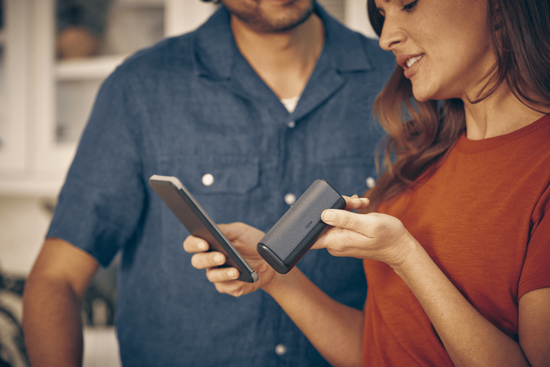 Woman looking at IQOS packaging