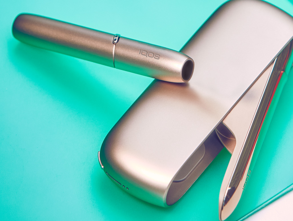 Gold IQOS DUO on a laptop