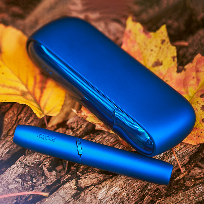 Brilliant gold IQOS 3 DUO on top of charger