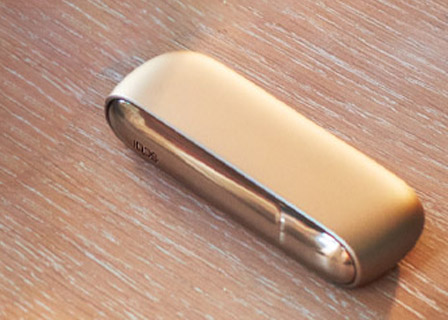 Brilliant gold IQOS 3 Duo holder and charger on a leather wallet