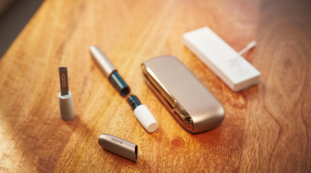  IQOS holder, charger and other accessories on a table