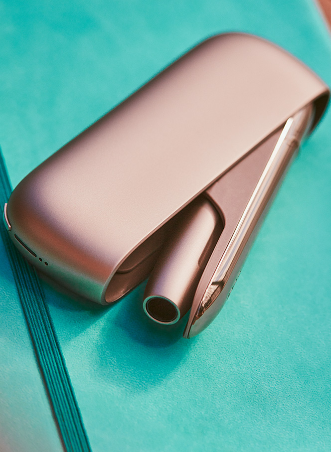 Gold IQOS DUO on a wooden table