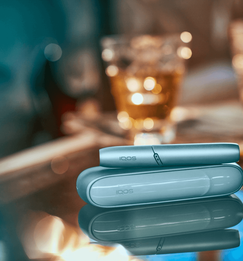 close-up shot of a shiny gold iqos device