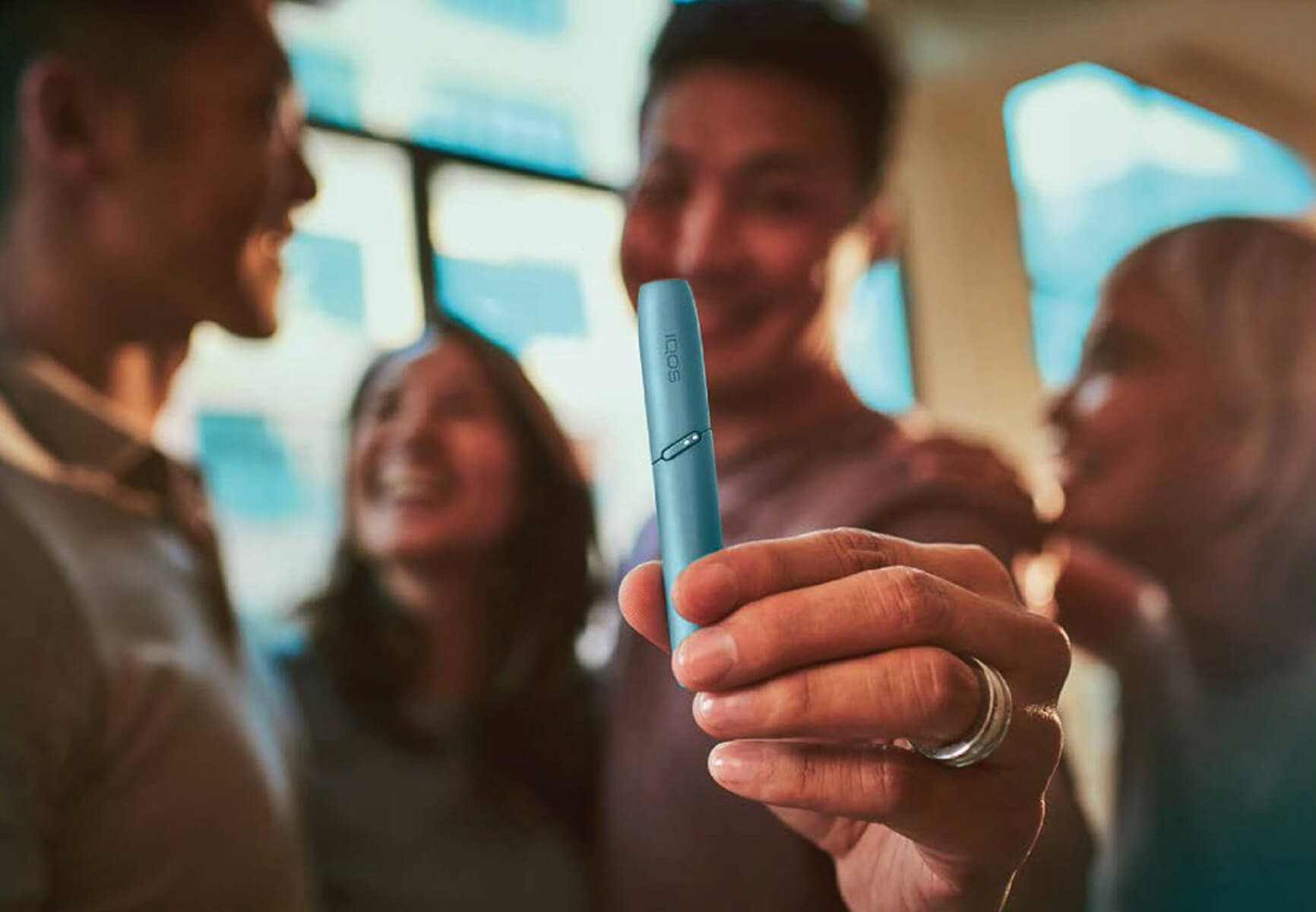 close-up shot of a black woman holding an iqos device
